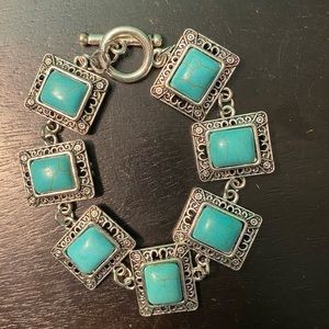 Rectangular shaped turquoise inspired charm bracelet, with toggle enclosure.
